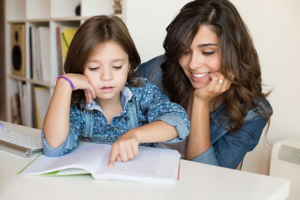 mamma supporta figlia standole accanto mentre legge